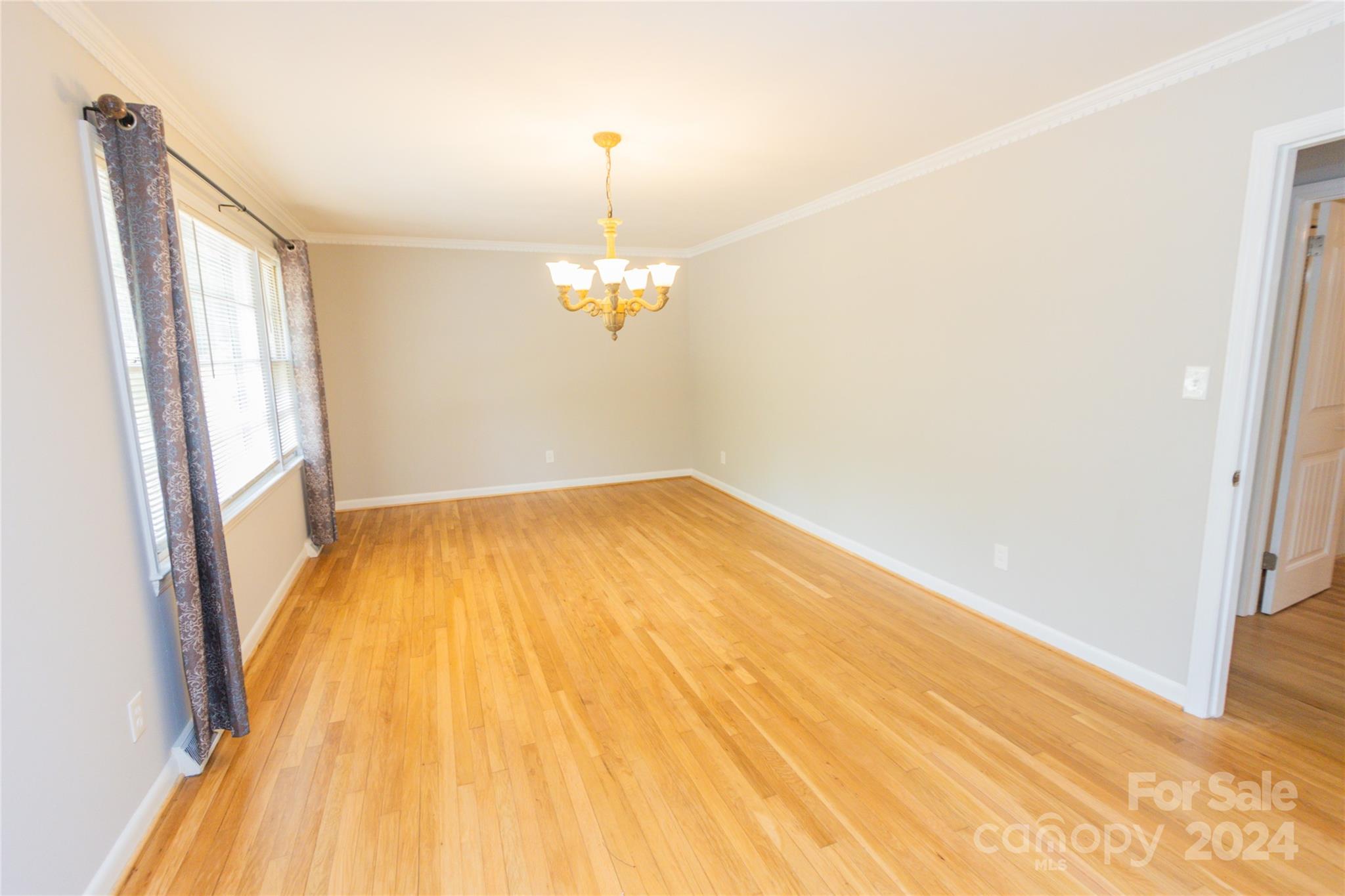 111 Colonial Avenue Lancaster, SC 29720 - Photo 9 of 40 a view of empty room with wooden floor and fan