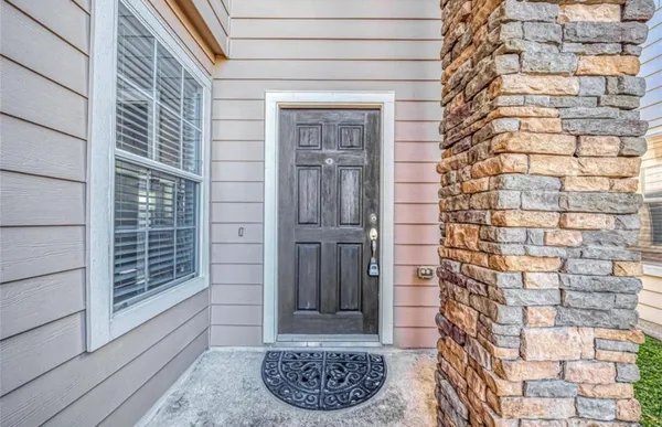 a view of a wooden door and a window
