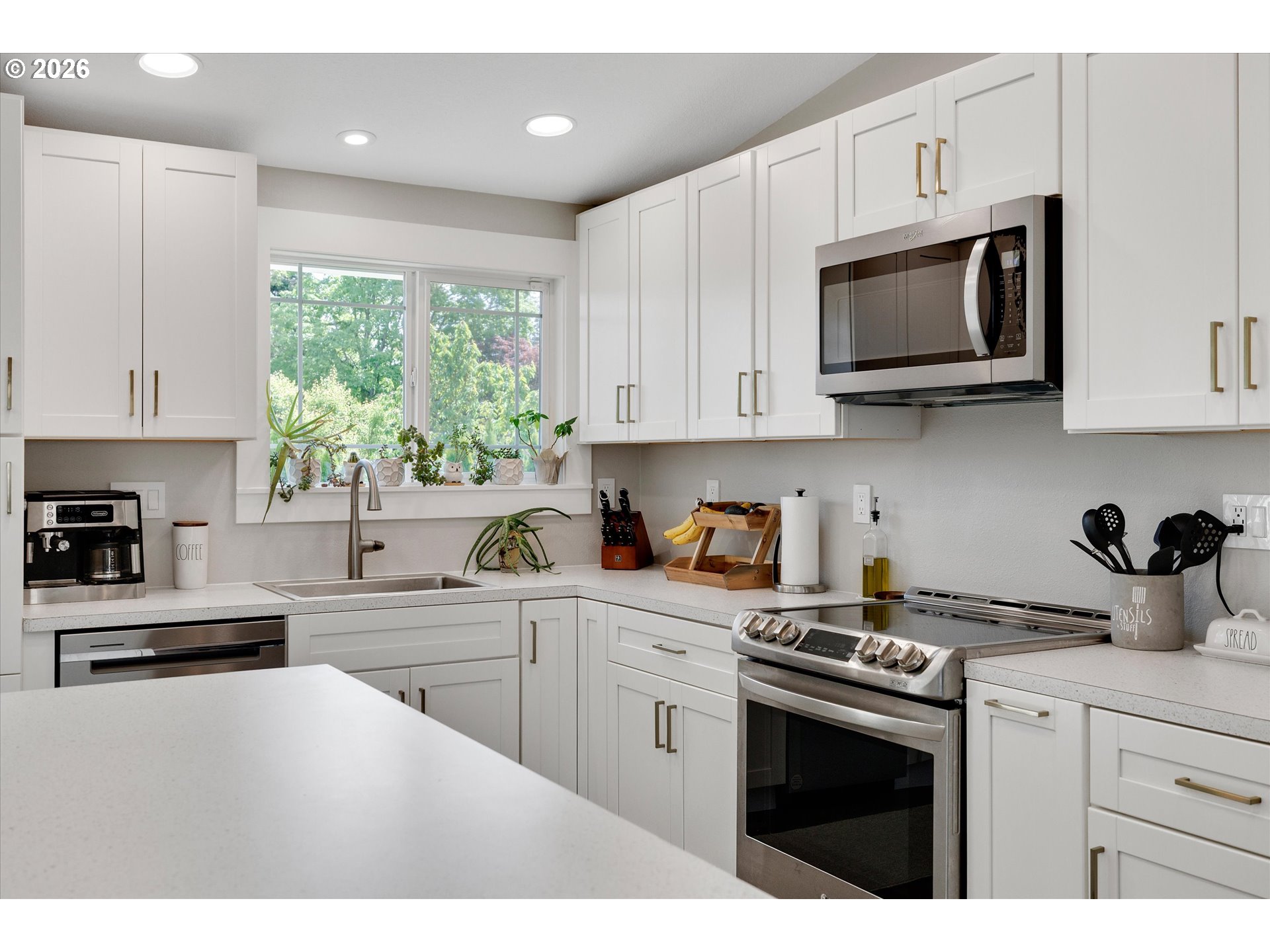 1144 North Pine Street Canby, OR 97013 - Photo 14 of 41 a kitchen with stainless steel appliances granite countertop white cabinets a sink a stove a microwave and window