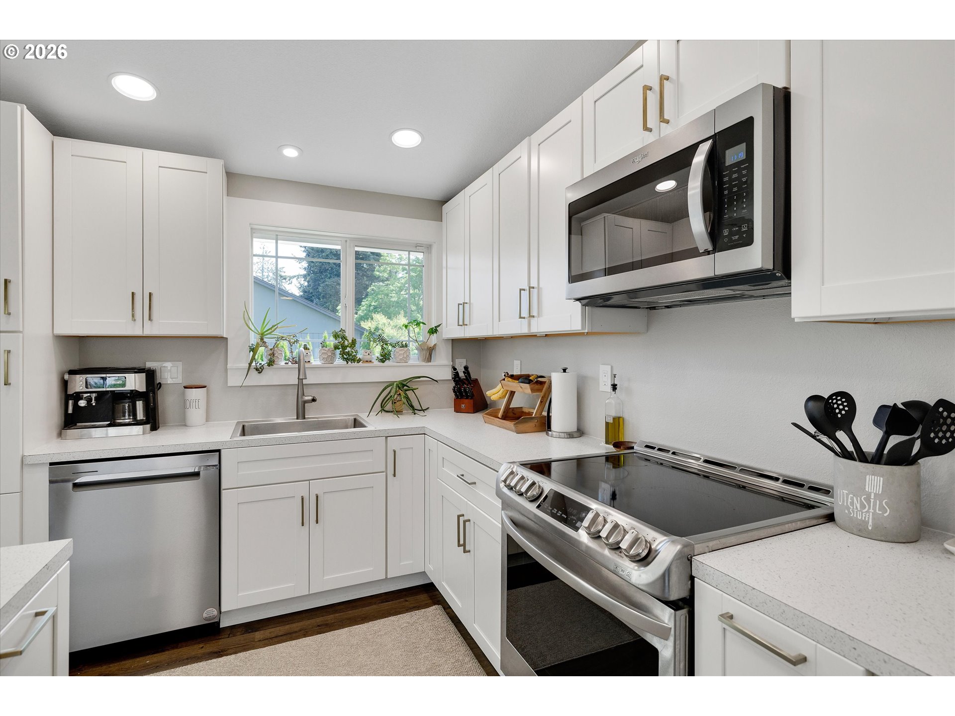 1144 North Pine Street Canby, OR 97013 - Photo 15 of 41 a kitchen with a sink a microwave and cabinets