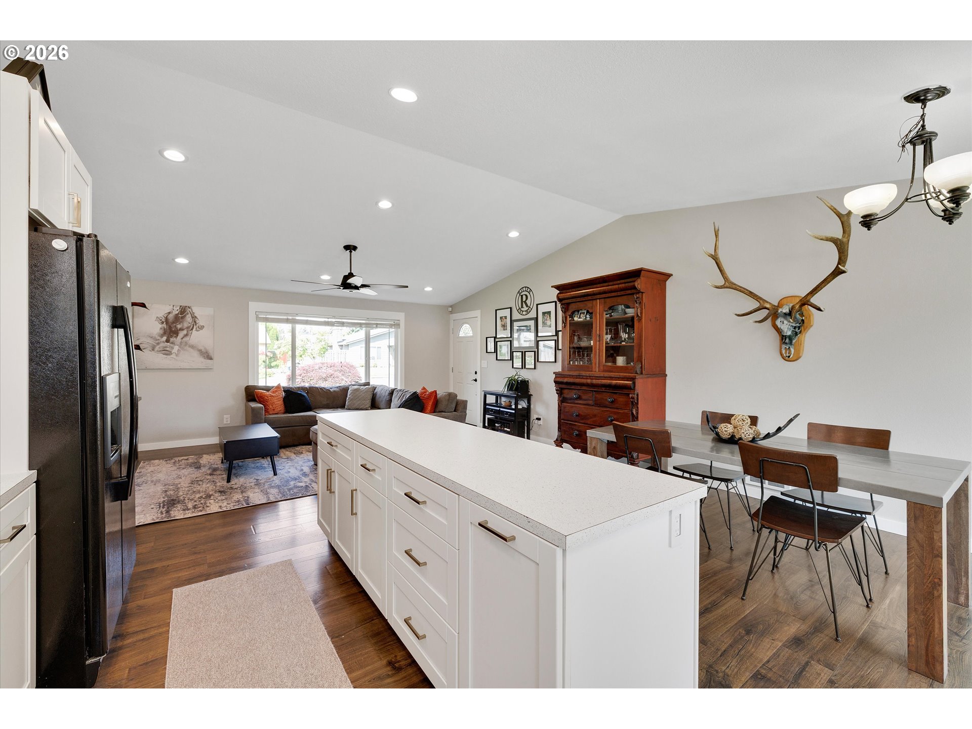 1144 North Pine Street Canby, OR 97013 - Photo 16 of 41 a large living room with stainless steel appliances kitchen island granite countertop furniture and a living room