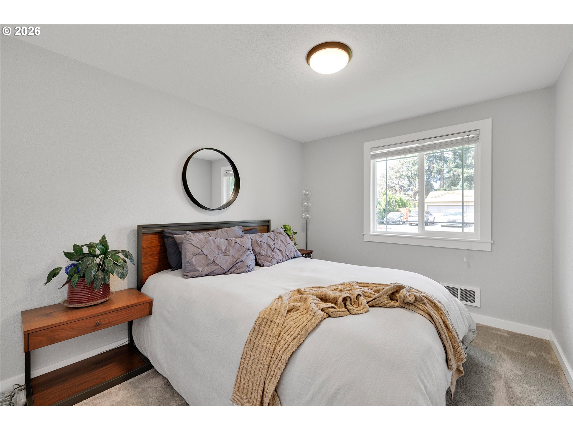 1144 North Pine Street Canby, OR 97013 - Photo 27 of 41 a bed sitting in a bedroom next to a window