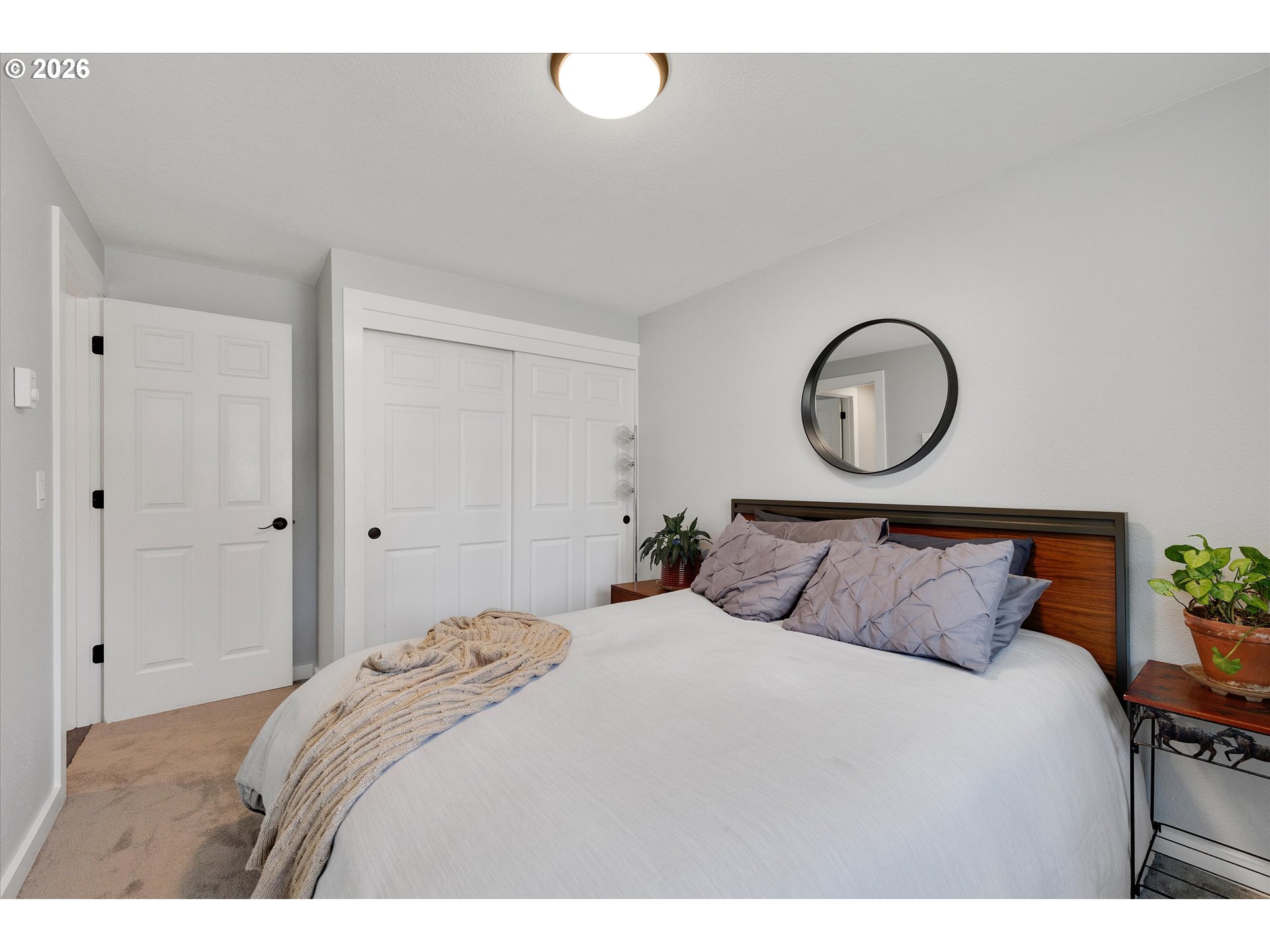 1144 North Pine Street Canby, OR 97013 - Photo 28 of 41 a bedroom with a bed and a painting on the wall