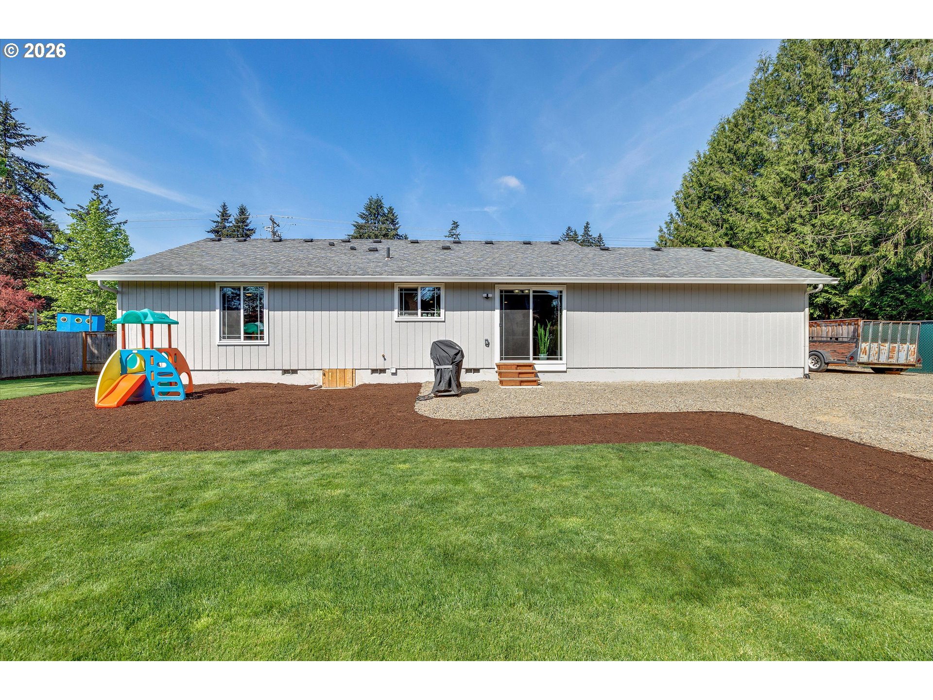 1144 North Pine Street Canby, OR 97013 - Photo 29 of 41 a group of people sitting in front of a house with a yard