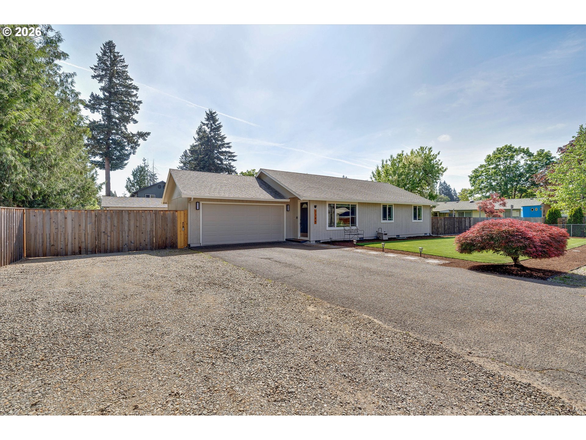 1144 North Pine Street Canby, OR 97013 - Photo 3 of 41 a front view of a house with a yard and garage