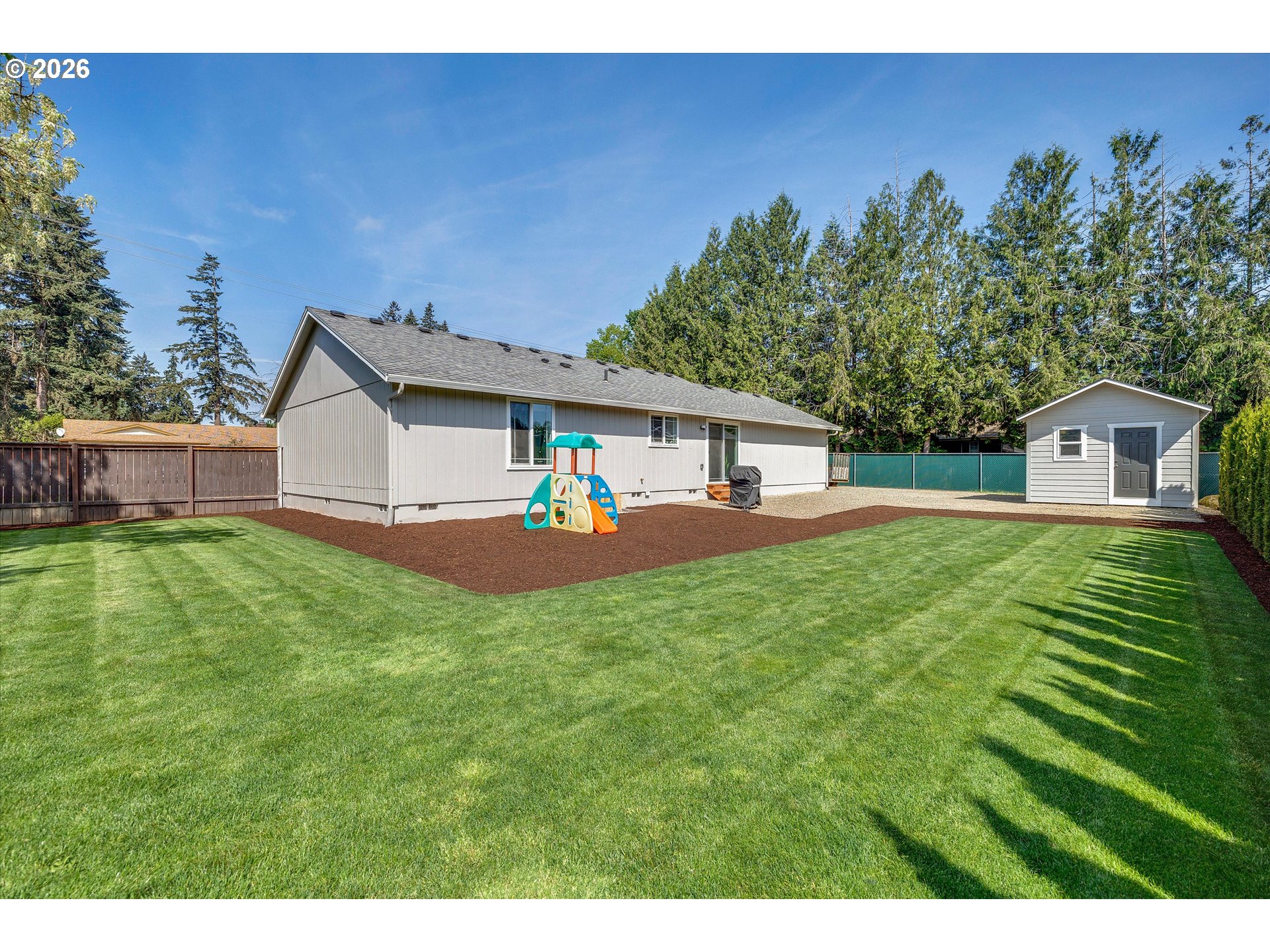 1144 North Pine Street Canby, OR 97013 - Photo 32 of 41 a front view of a house with garden