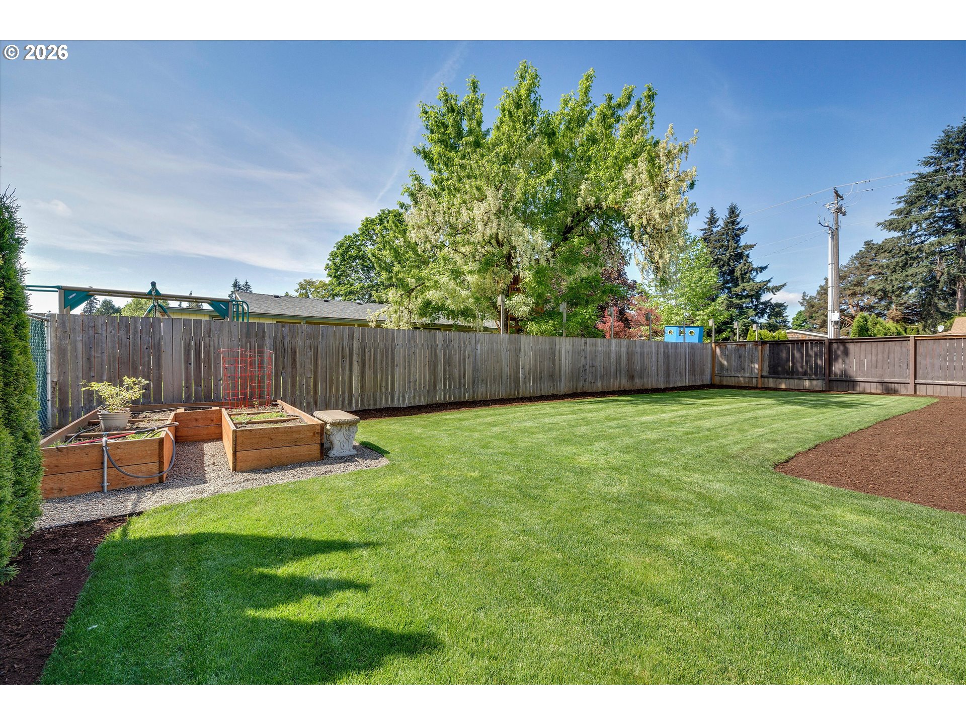 1144 North Pine Street Canby, OR 97013 - Photo 33 of 41 a view of a chair and table in the garden