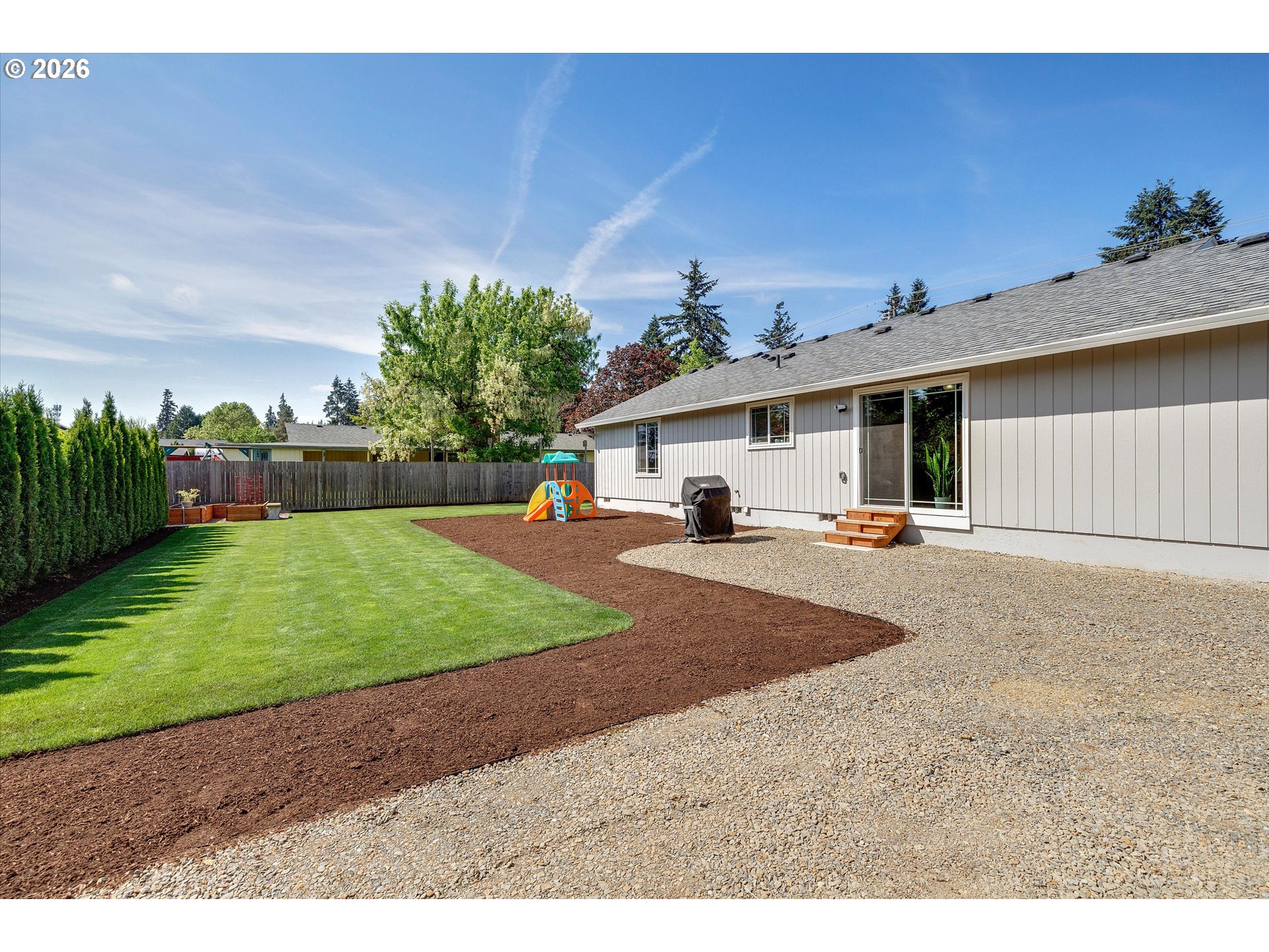 1144 North Pine Street Canby, OR 97013 - Photo 35 of 41 a view of a white house with a big yard and a large parking space