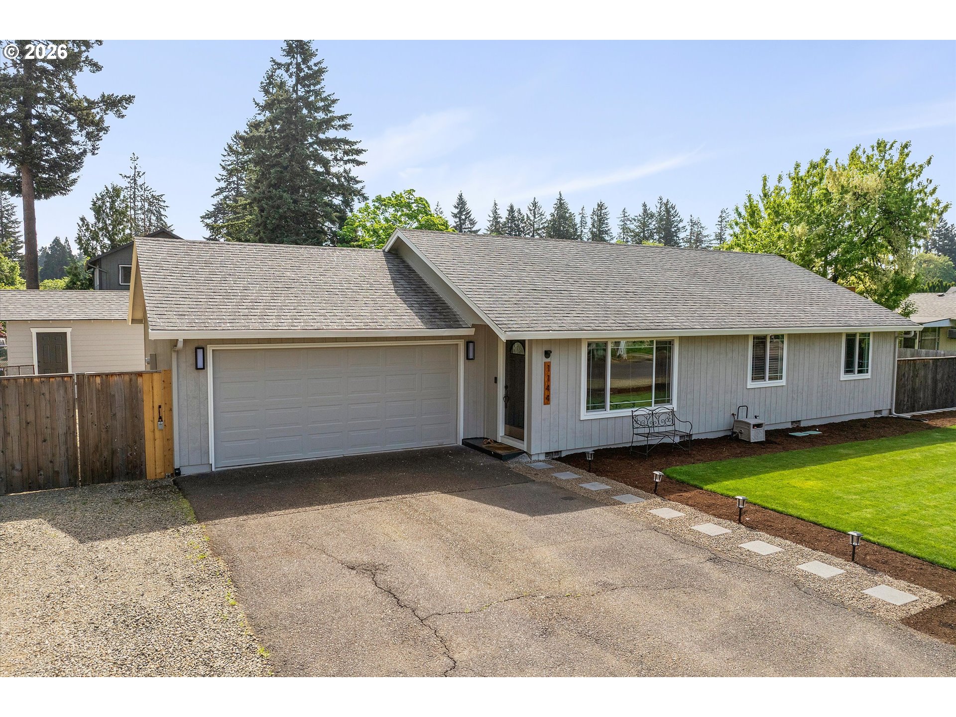 1144 North Pine Street Canby, OR 97013 - Photo 4 of 41 a view of a house with a yard and a garage