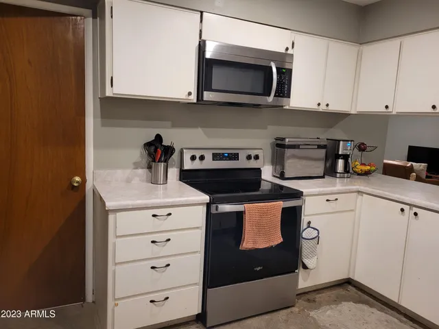 a kitchen with a sink stove and cabinets