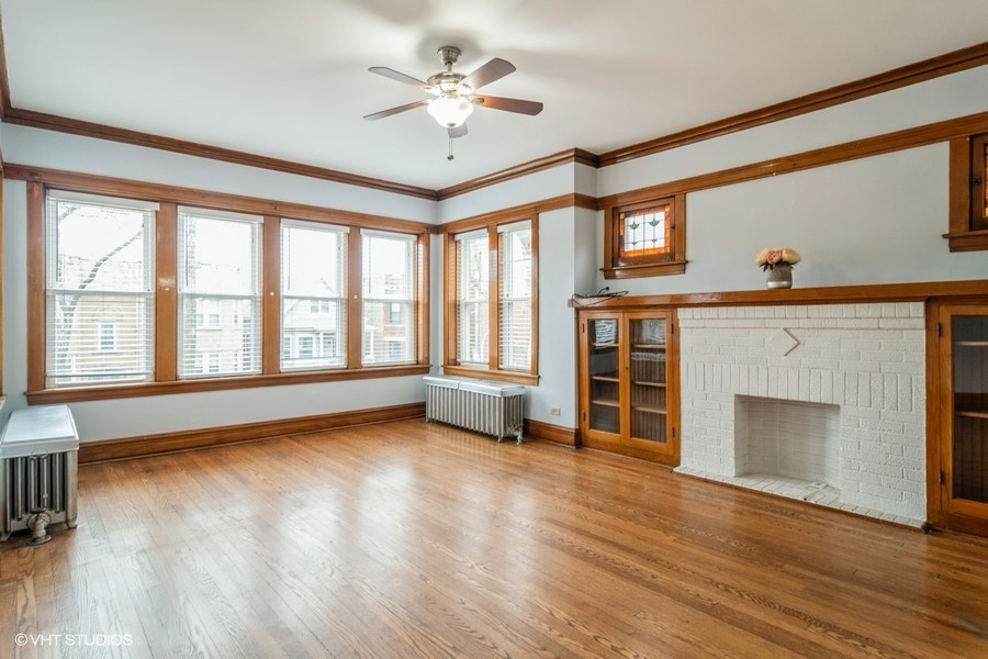3935 North Christiana Avenue, Unit 2 Chicago, IL 60618 - Photo 2 of 12 wooden floor fireplace and windows in an empty room