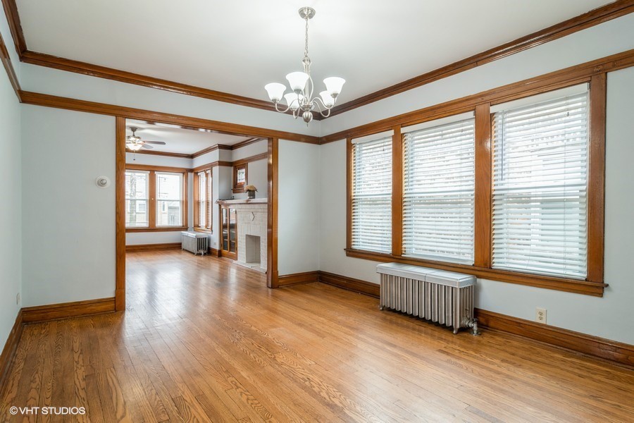3935 North Christiana Avenue, Unit 2 Chicago, IL 60618 - Photo 6 of 12 a view of an empty room with wooden floor and a window