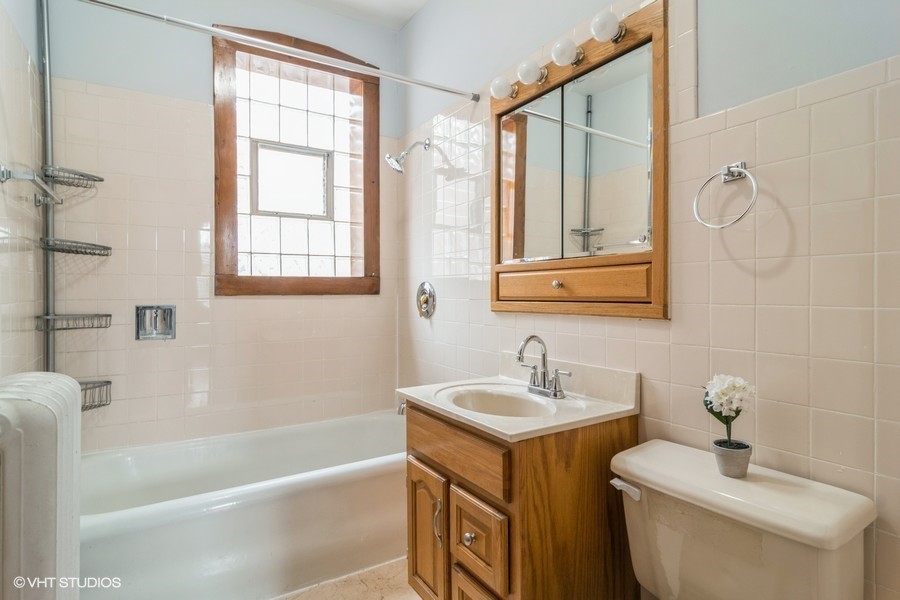 3935 North Christiana Avenue, Unit 2 Chicago, IL 60618 - Photo 10 of 12 a bathroom with a sink toilet and shower