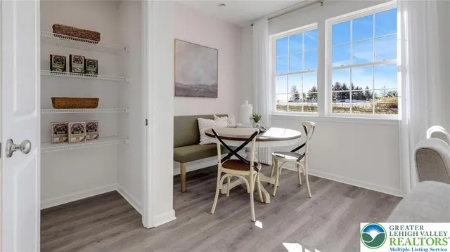 a dining room with furniture and window