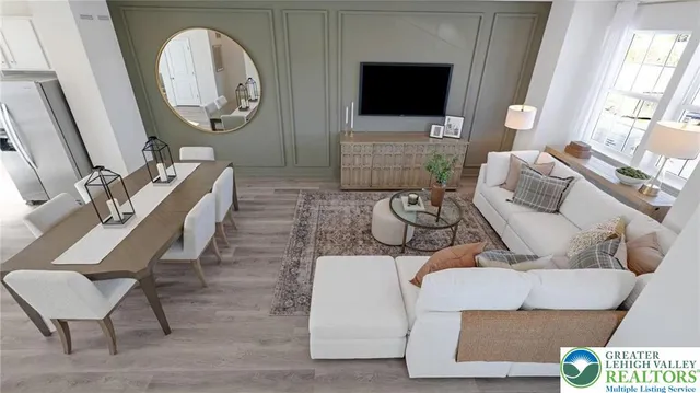 a living room with furniture a flat screen tv and a fireplace