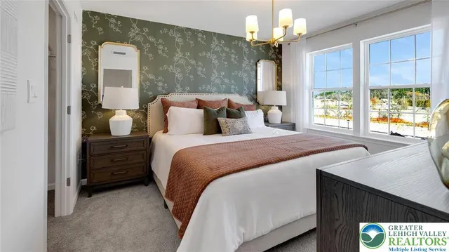 a bedroom with a bed and a chandelier