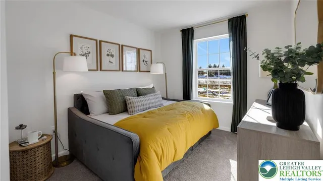 a bedroom with a bed and a potted plant