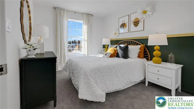 a bedroom with a bed and a mirror on the dresser