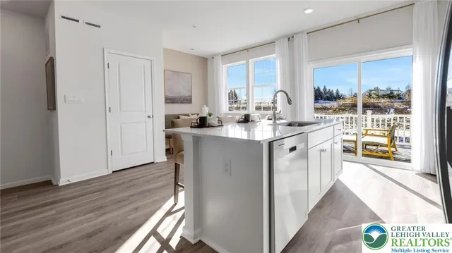 a kitchen with sink cabinets and wooden floor