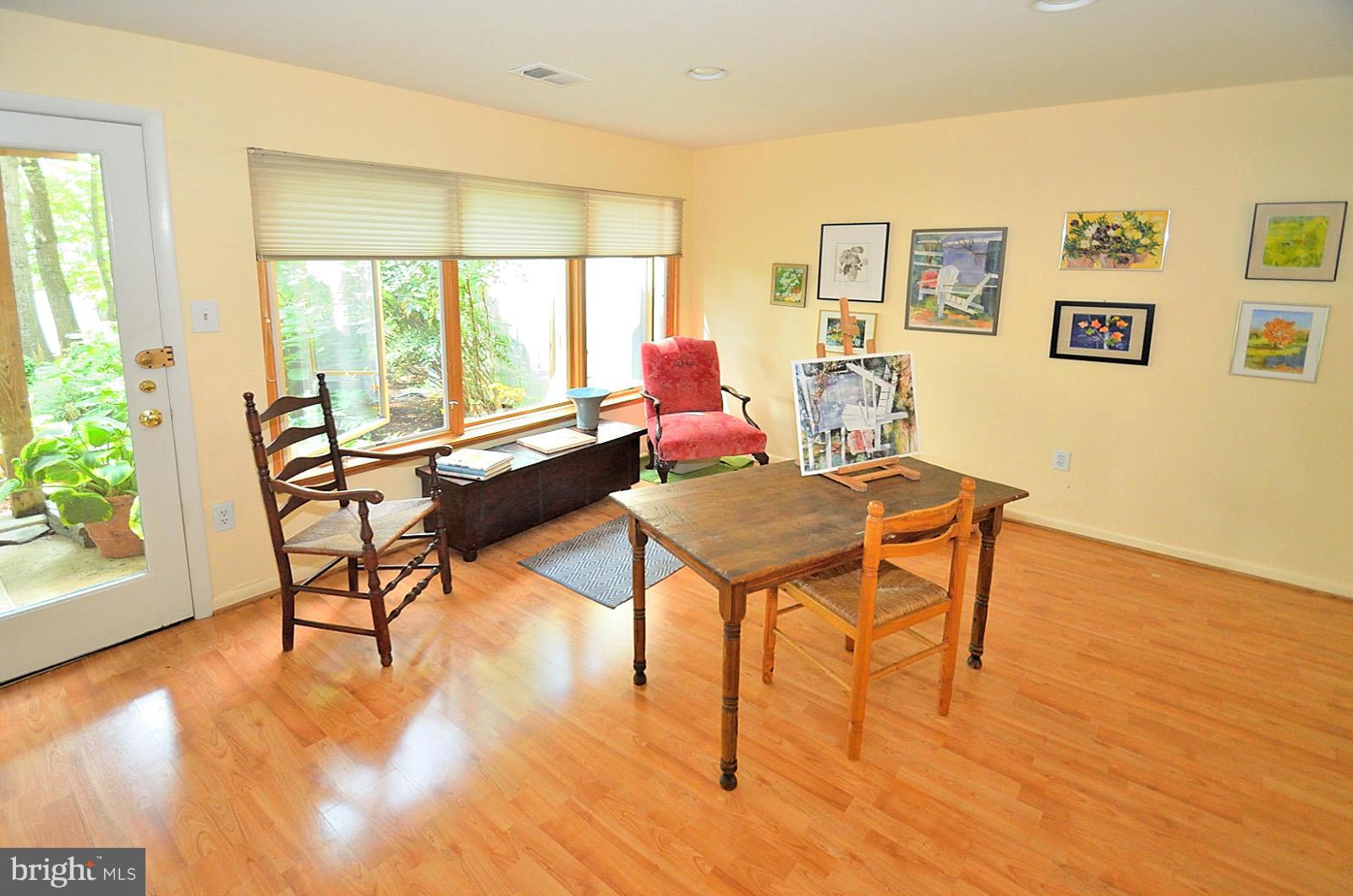 1602 Waters Edge Lane Reston, VA 20190 - Photo 4 of 28 a living room with furniture a table and wooden floor next to a window