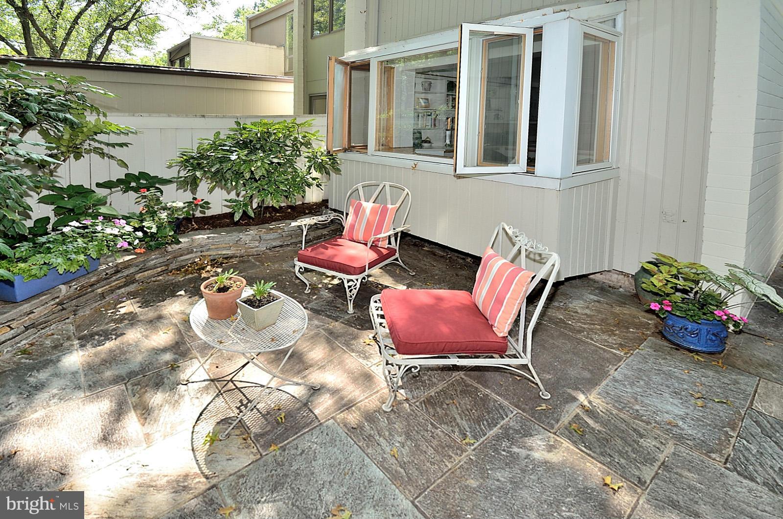 1602 Waters Edge Lane Reston, VA 20190 - Photo 9 of 28 a view of a chairs and table in a back yard of the house