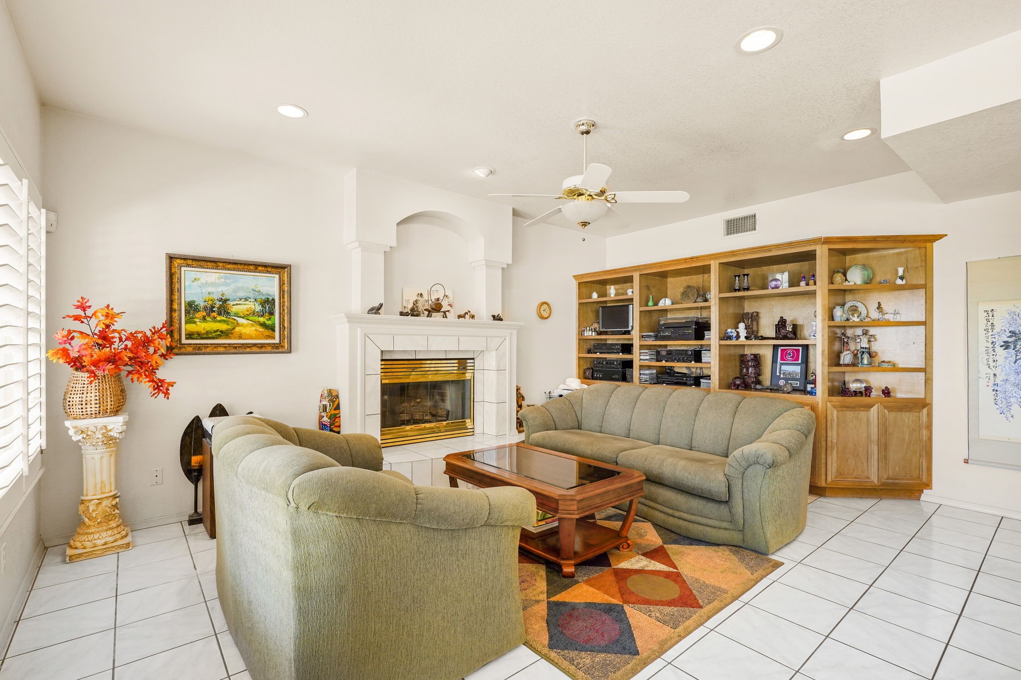 6574 Eagle Ridge Drive El Paso, TX 79912 - Photo 22 of 50 a living room with furniture a fireplace and a potted plant
