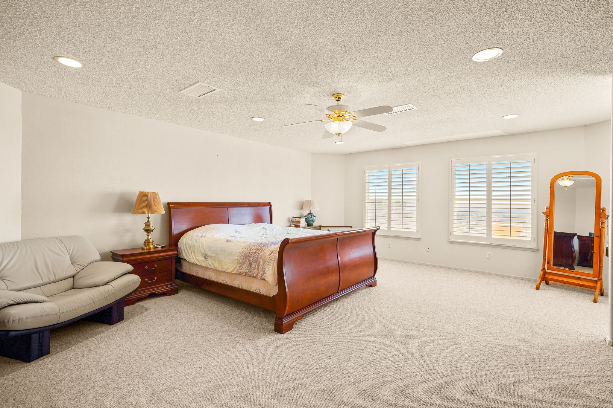 6574 Eagle Ridge Drive El Paso, TX 79912 - Photo 31 of 50 a spacious bedroom with a bed and a couch