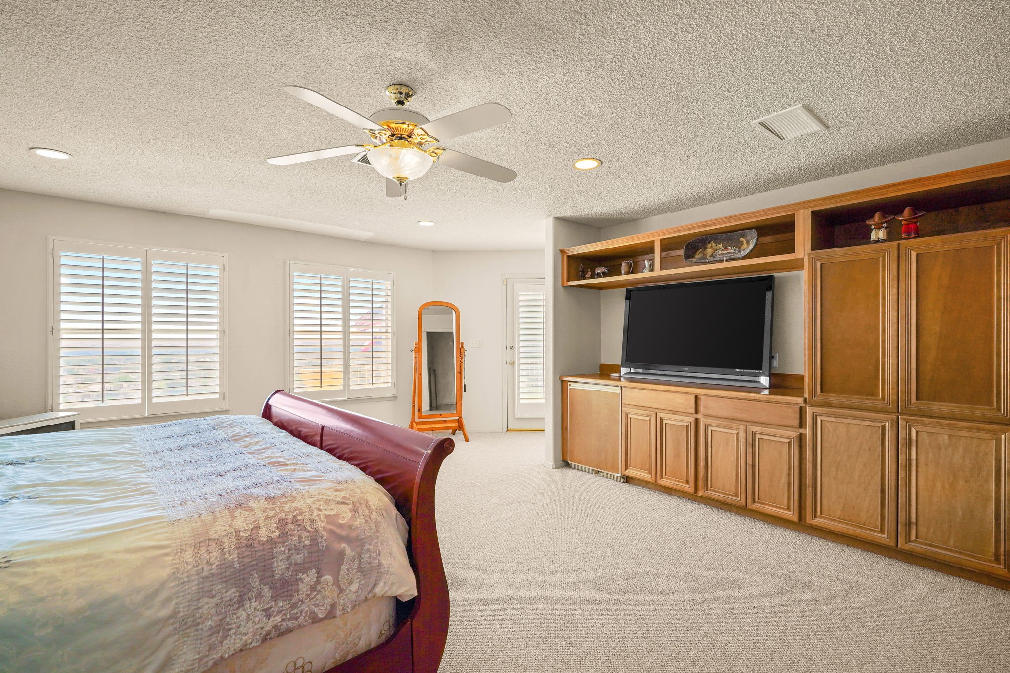 6574 Eagle Ridge Drive El Paso, TX 79912 - Photo 32 of 50 a bedroom with chandelier and flat screen tv