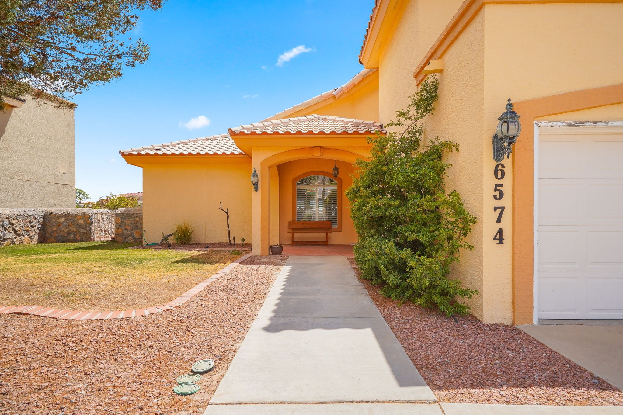6574 Eagle Ridge Drive El Paso, TX 79912 - Photo 4 of 50 a front view of a house with a yard and garage