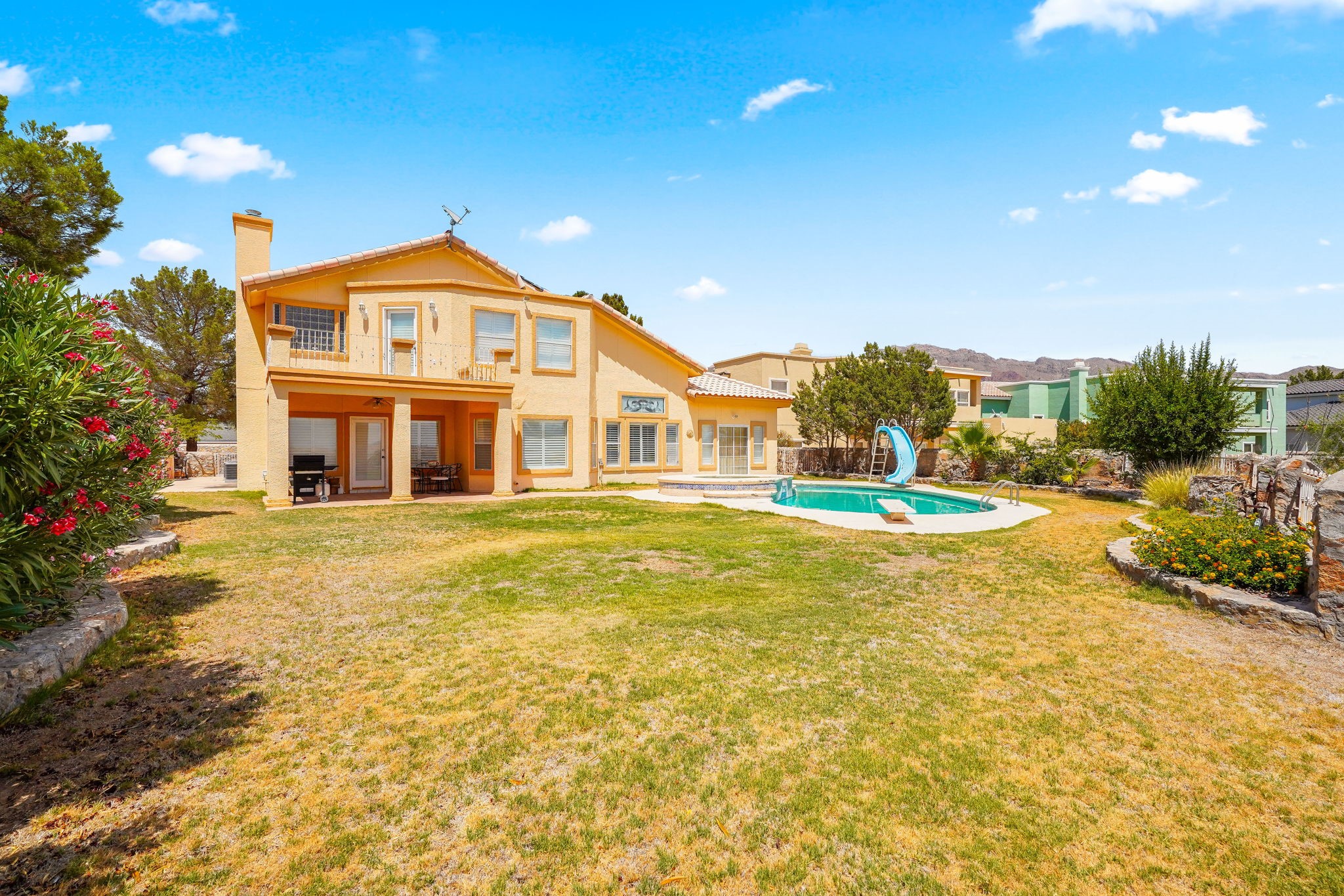 6574 Eagle Ridge Drive El Paso, TX 79912 - Photo 44 of 50 a front view of a house with a yard