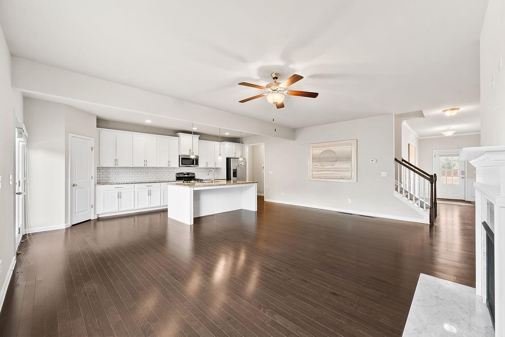 2415 Matlin Way Buford, GA 30519 - Photo 14 of 65 a view of an empty room with kitchen and window