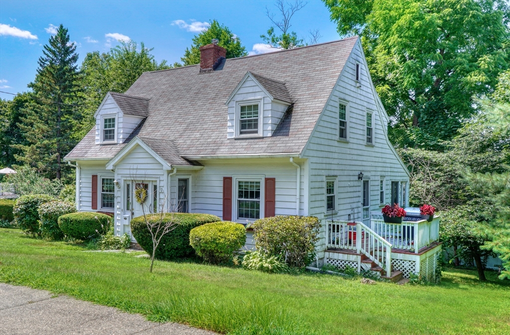 a front view of house with yard and green space