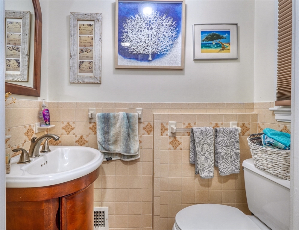 27 Ledyard Road Winchester, MA 01890 - Photo 12 of 38 a bathroom with a toilet sink and mirror