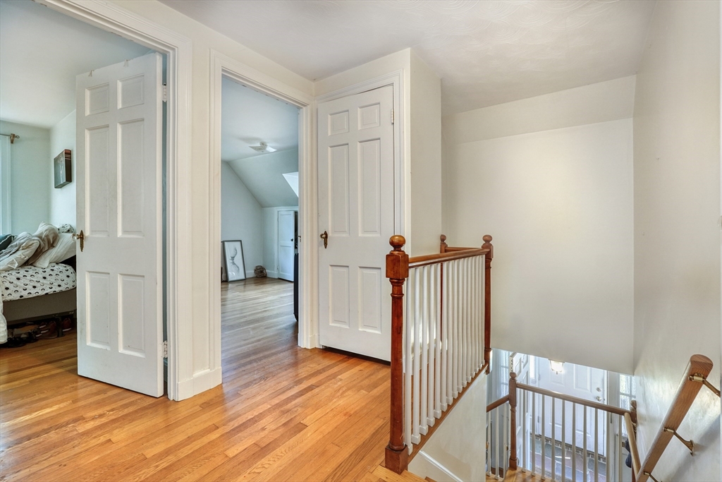 27 Ledyard Road Winchester, MA 01890 - Photo 15 of 38 a view of a hallway with wooden floor and staircase