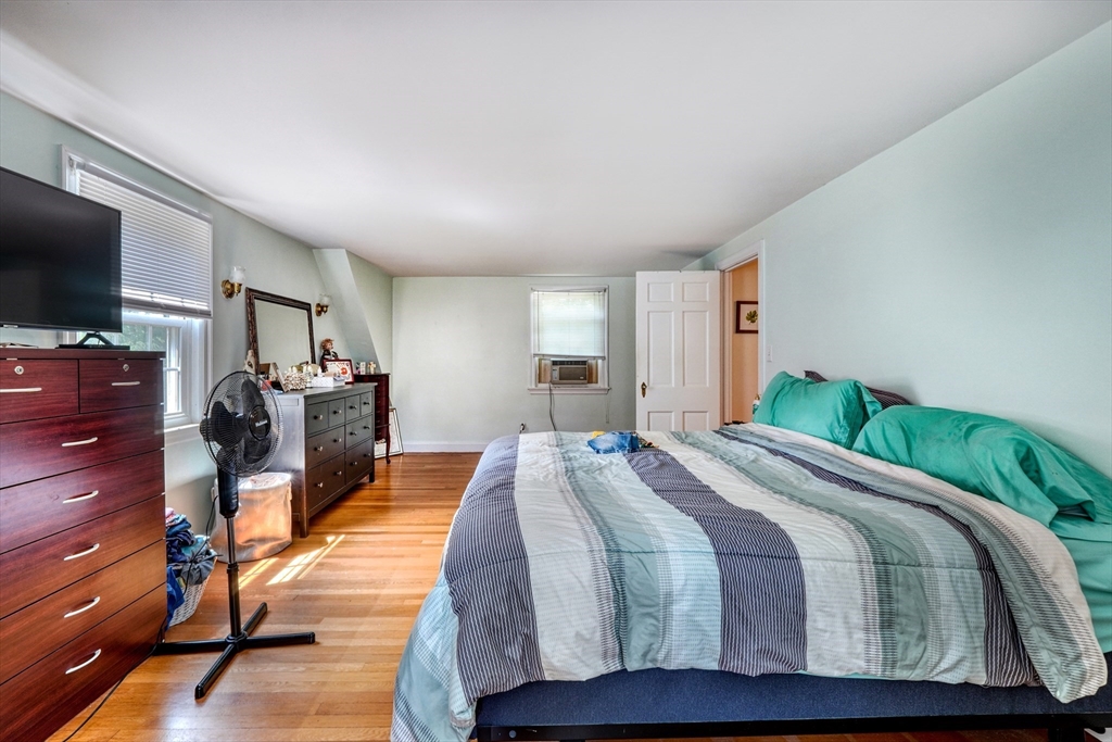 27 Ledyard Road Winchester, MA 01890 - Photo 16 of 38 a bedroom with a bed and wooden floor