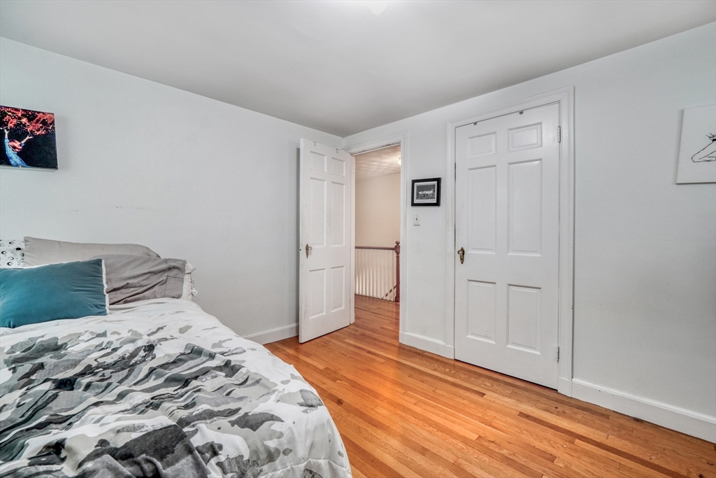 27 Ledyard Road Winchester, MA 01890 - Photo 18 of 38 a bedroom with a bed and hallway