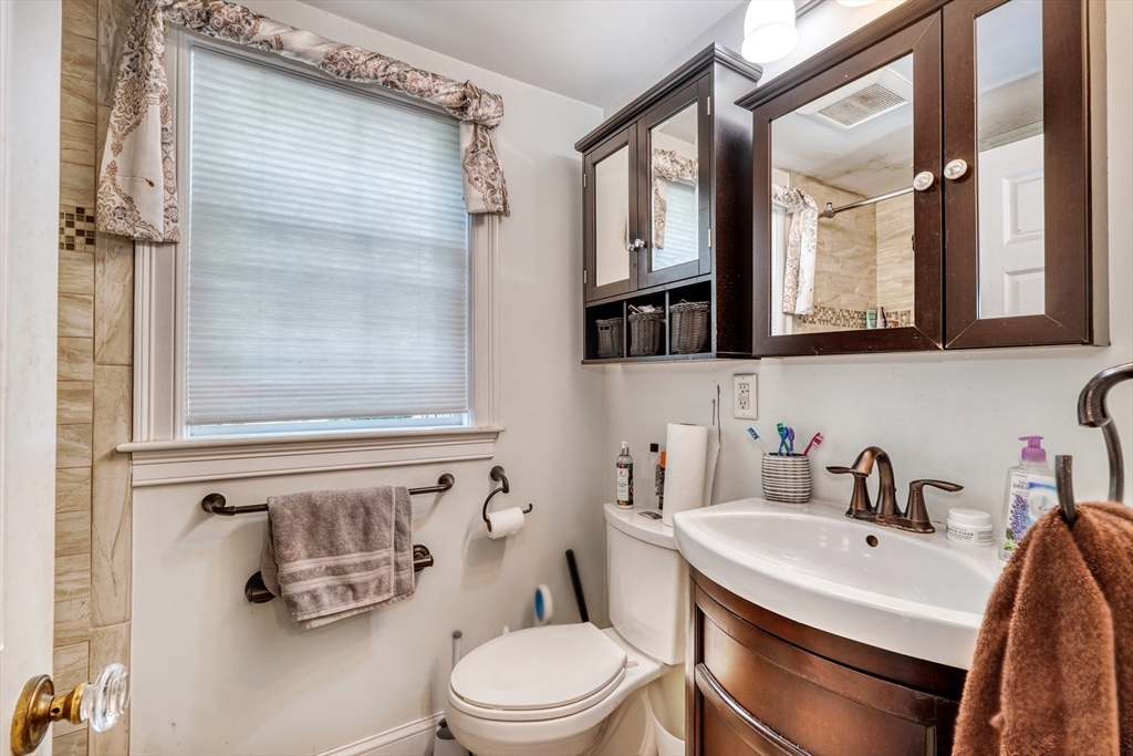 27 Ledyard Road Winchester, MA 01890 - Photo 21 of 38 a bathroom with a sink a toilet and a mirror
