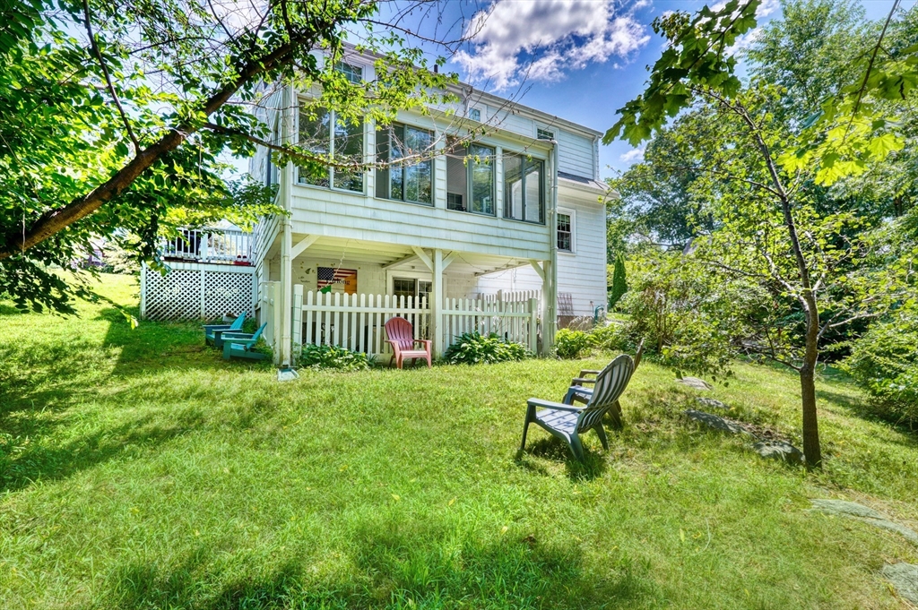 27 Ledyard Road Winchester, MA 01890 - Photo 27 of 38 a view of house in front of a big yard with large trees and plants