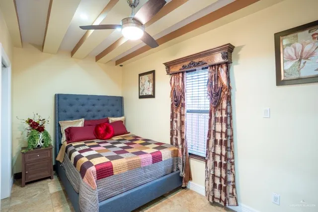 a bedroom with a bed and a painting on the wall