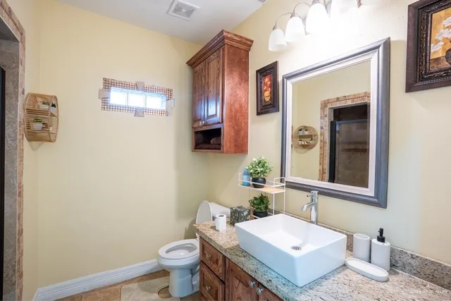 a bathroom with a sink toilet and mirror