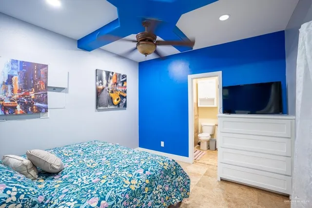 a bedroom with a bed and a television