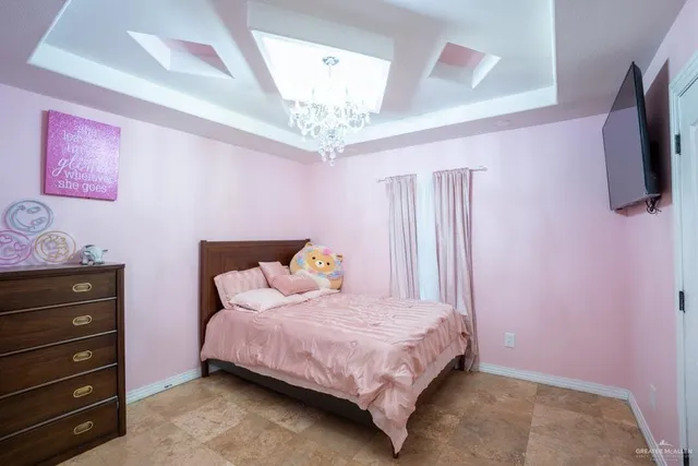 a bedroom with a bed a flat screen tv and dresser