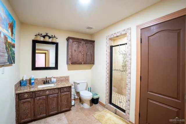 a spacious bathroom with a double vanity sink and a mirror
