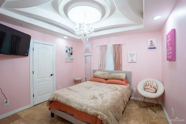 a bedroom with a bed and a chandelier