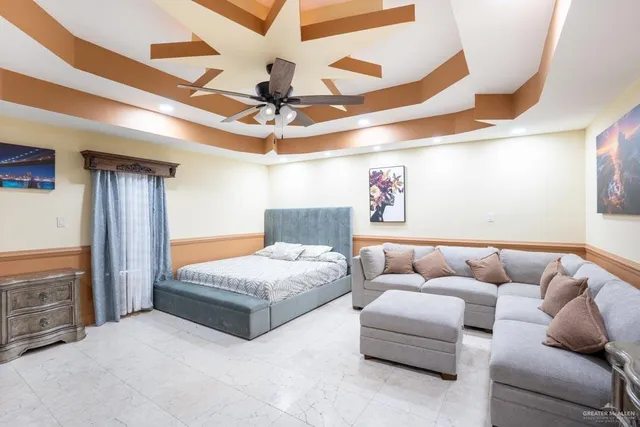 a bedroom with a bed and ceiling fan
