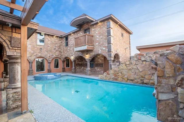 a view of pool with seating area