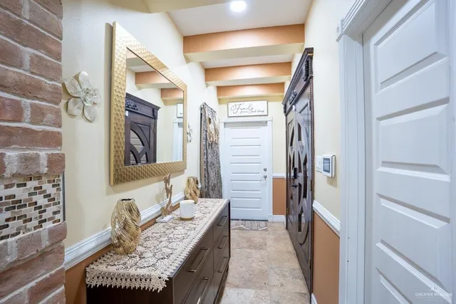 a hallway with furniture and wooden floor