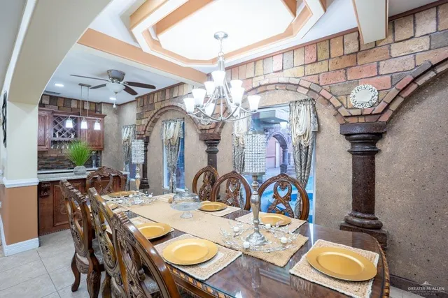 a view of a dining room with furniture and chandelier