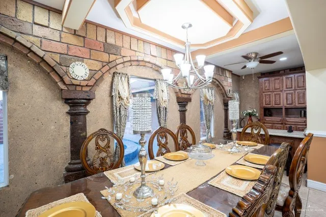 a view of a dining room with furniture and chandelier