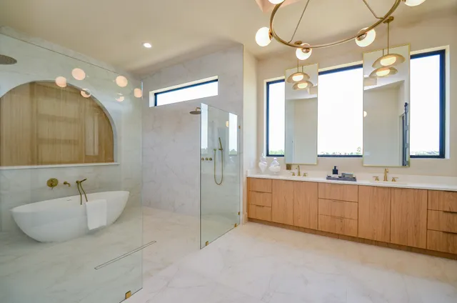 a spacious bathroom with a double vanity sink mirror and double